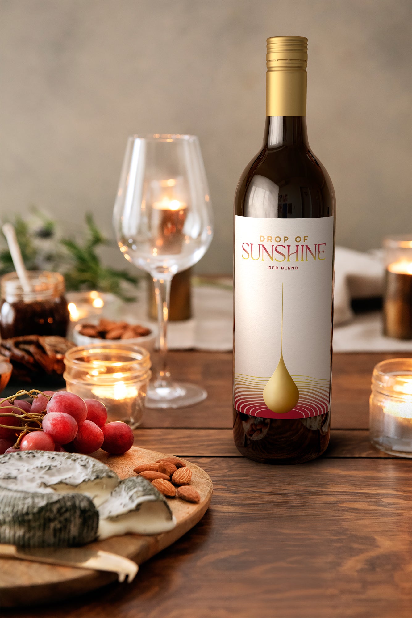 Drop of Sunshine Red Blend wine bottle on a table paired with charcuterie
