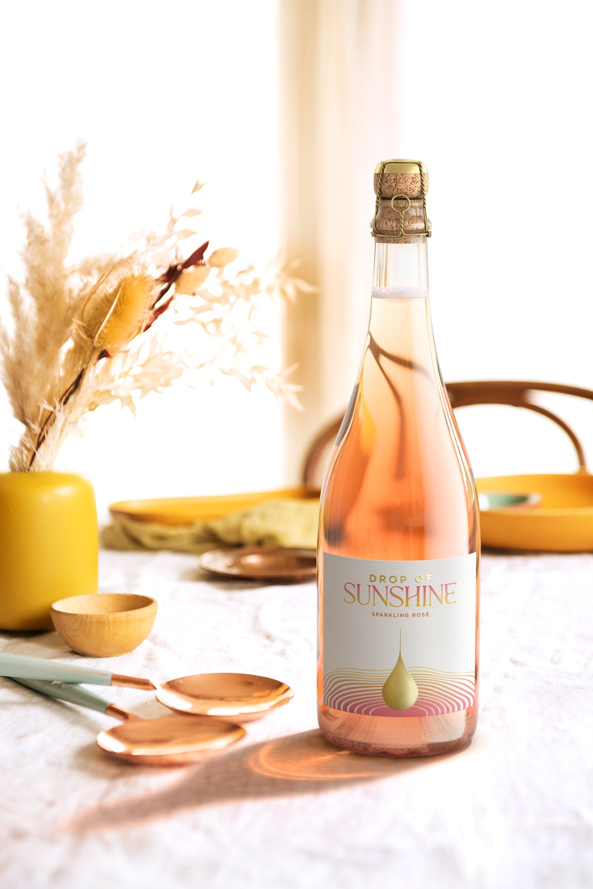 Drop of Sunshine Sparkling Rosé on a a set table